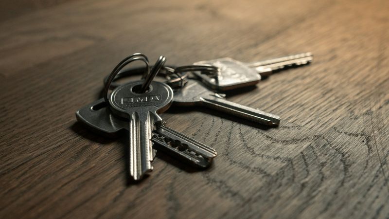 A bunch of keys on a wooden table