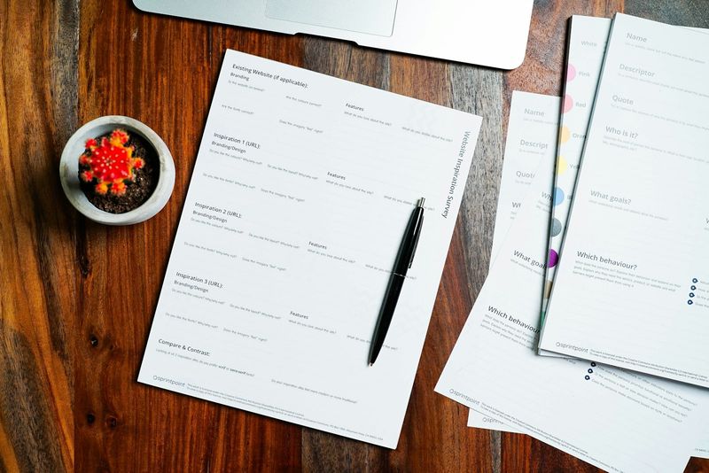 Documents and a pen on a wooden desk