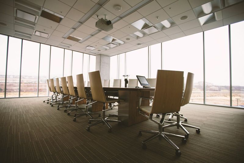 A long boardroom table with leather chairs