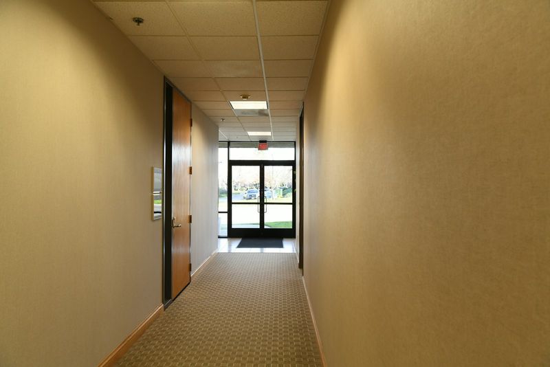 An office corridor leading to an exit door