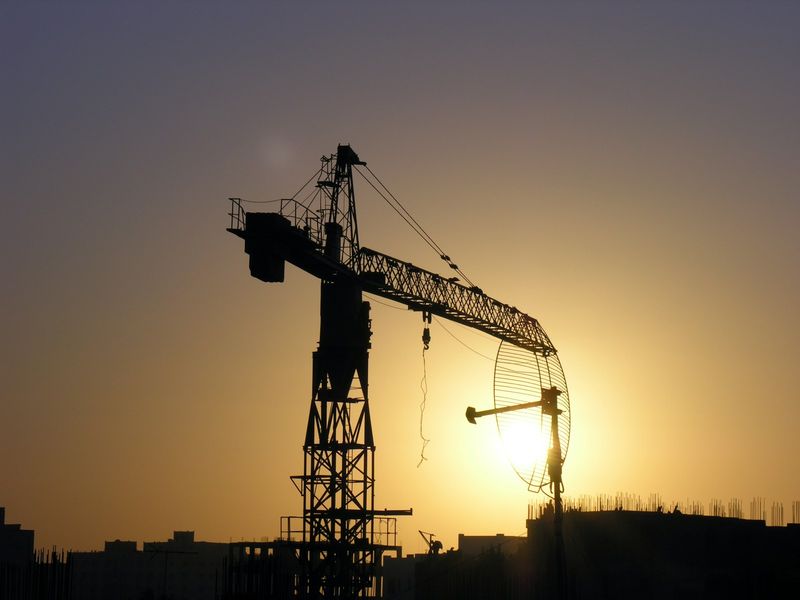 A construction crane against the evening sun